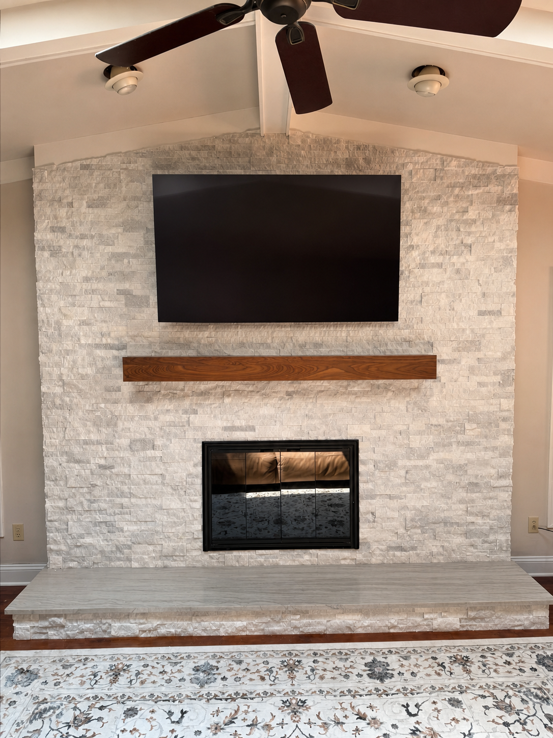 Cleaned portfolio view of stone fireplace and wood mantel completed by DHR